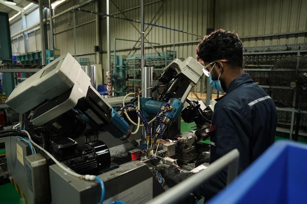 Welders fabricating heavy steel frames in the Thimark workshop