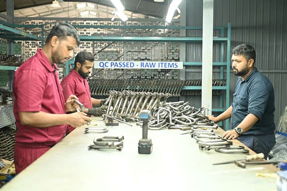 Thimark team inspecting QC-passed components at a workshop bench